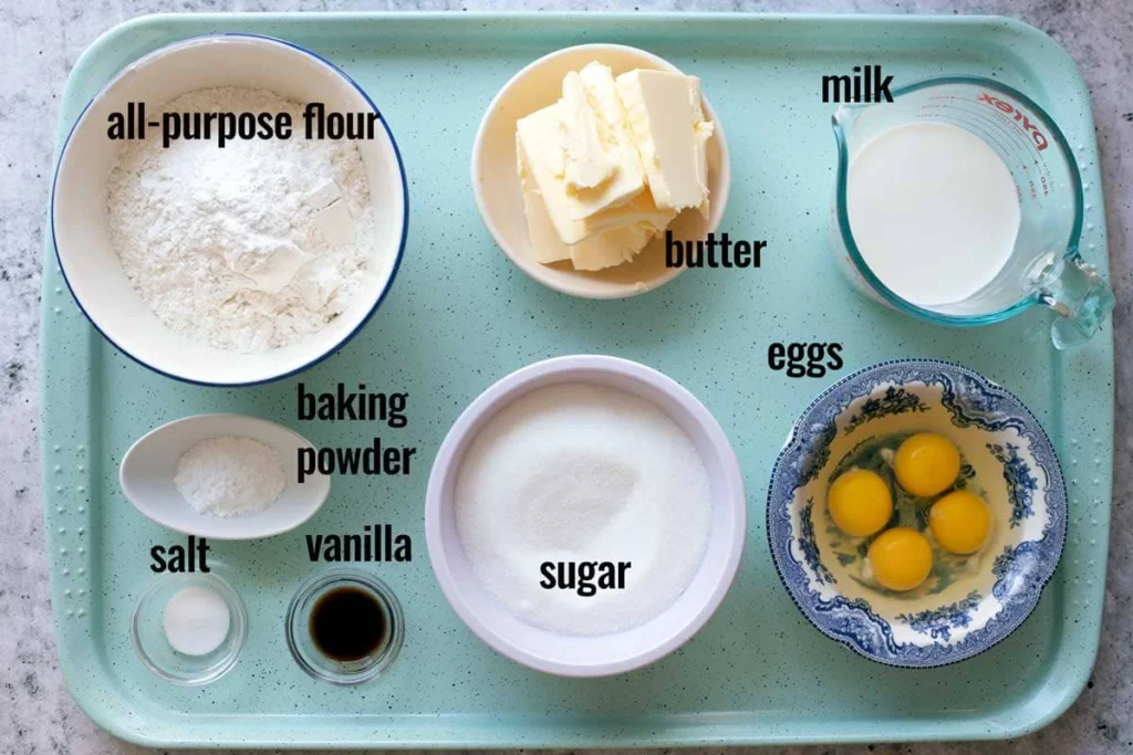 Measured ingredients for fluffy vanilla cake recipe including flour, sugar,